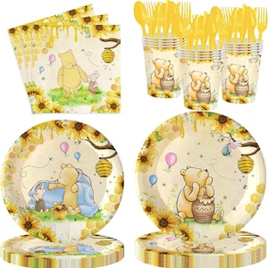 May include: A Winnie the Pooh themed party supply set featuring paper plates, napkins, and cups decorated with sunflowers, honeycombs, and bees. The items display illustrations of Pooh and Piglet, yellow plastic forks, and honey pots labeled Hunny.