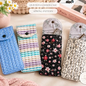 May include: Four rectangular quilted glasses cases with snap closures. One is blue with white dots, one has horizontal stripes in purple and teal, one is black with a red and pink floral print, and one is cream with a black mushroom line drawing pattern.