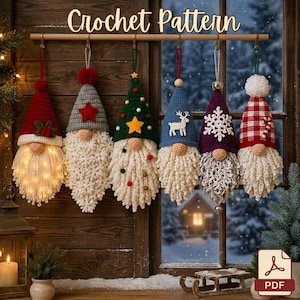 May include: Six crochet gnome ornaments hanging from a wooden rod, each featuring a unique hat design including red, grey with a star, green with a tree, blue with a reindeer, purple with a snowflake, and red plaid, all with textured white beards.