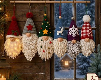 May include: Six crochet gnome ornaments hanging from a wooden rod, each featuring a unique hat design including red, grey with a star, green with a tree, blue with a reindeer, purple with a snowflake, and red plaid, all with textured white beards.
