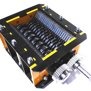 May include: A heavy-duty industrial shredder mechanism featuring a rectangular yellow and black metal frame. The device contains multiple parallel rotating steel cutting blades and gear assemblies on the side, secured with silver-colored bolts.