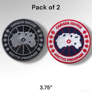 May include: A pack of 2 circular embroidered patches measuring 3.75 inches. One patch is black with silver text and a silver map, the other is white with red text and a white map. Both feature the text CANADA GOOSE ARCTIC PROGRAM and maple leaf icons.