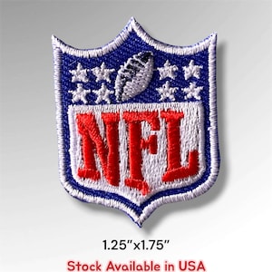 May include: A shield-shaped embroidered patch featuring a blue background with white stars and a football graphic above the red text NFL. The patch has a white border and measures 1.25 inches by 1.75 inches as indicated by the text below it.