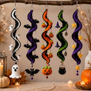 May include: Five hanging crochet spiral decorations featuring Halloween themes. The first is black and white with ghosts, the second is purple and black with bats, the third is orange and black with pumpkins, the fourth is green and black with witch hats and a cauldron, and the fifth is purple and black with yellow stars.