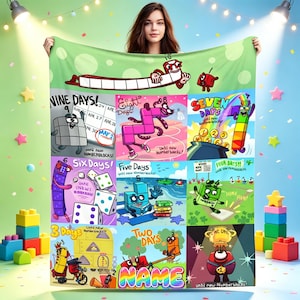 May include: A rectangular fleece blanket featuring a colorful grid of Numberblocks characters and countdown text. Each square displays a different number from one to nine with playful illustrations, bright graphics, and the text 'NAME' at the bottom.