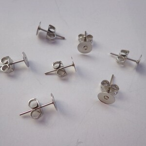 100 PCS Nickel Free Surgical Steel Stud Earnuts and 6mm Flat Pads,White K Earring Posts with Back Stoppers(Nickel free ).