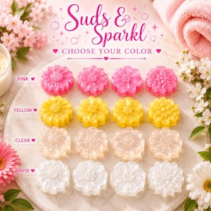 May include: Sixteen flower-shaped soaps arranged in four rows by colour: pink, yellow, clear, and white. The text 'Suds & Sparkl' and 'CHOOSE YOUR COLOUR' is displayed above the soaps. Each row features four distinct floral designs with varying petal patterns.