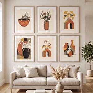 May include: A set of six framed wall art prints featuring illustrations of various vases and botanical elements in shades of terracotta, black, and cream. The artwork displays stylised floral arrangements and geometric pottery shapes.