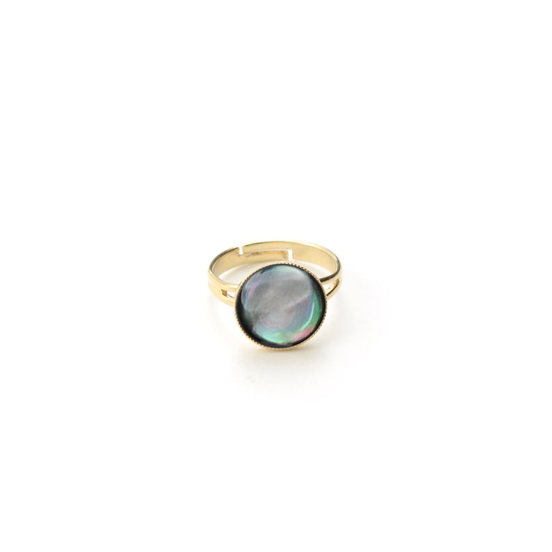 May include: A gold-toned adjustable ring featuring a large, iridescent, round stone. The stone displays a mix of colors, including blues, greens, and purples. The ring's band is simple and elegant, with a classic design.