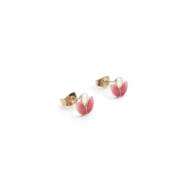 May include: A pair of gold stud earrings with pink and white flower designs.