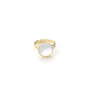 May include: A gold-toned adjustable ring featuring a large, round, iridescent mother-of-pearl center stone. The ring has a simple, elegant design, with a thin band and a decorative edge around the stone.