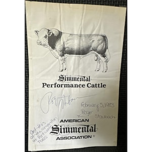 Könnte beinhalten: Ein weißes Papierdokument mit einer schwarz-weißen Illustration eines Stiers. Der Text lautet Simmental Performance Cattle, American Simmental Association und February 5, 1983. Es enthält eine handschriftliche Unterschrift von Roger Staubach und eine Notiz über Fort Worth.
