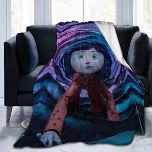 May include: A plush throw blanket featuring a stylized illustration of a character with blue hair, large light blue eyes, and a red polka-dot long-sleeve shirt. The background consists of swirling shades of deep purple, blue, and black tones.