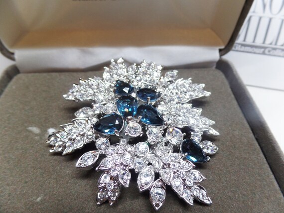 NOLAN MILLER Signed Exquisite Blue Crystal Floral Brooch