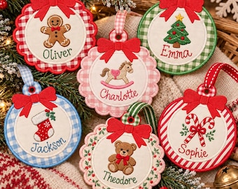 May include: Six round fabric Christmas ornaments featuring embroidered designs including a gingerbread man, rocking horse, Christmas tree, stocking, teddy bear, and candy canes. Each ornament has a red bow and a name embroidered in cursive.
