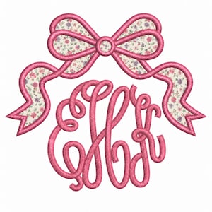 May include: An embroidery design featuring a pink stitched monogram with three intertwined letters. Above the monogram is a decorative bow with pink stitched outlines and a floral fabric fill pattern featuring small red, purple, and green flowers.