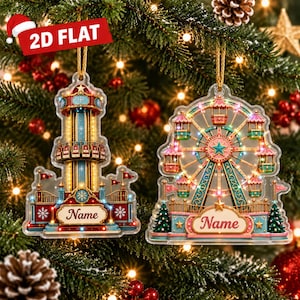 May include: Two flat acrylic Christmas ornaments featuring carnival ride designs. The left ornament depicts a drop tower ride, and the right ornament shows a Ferris wheel. Both ornaments include a blank white banner with the text Name.