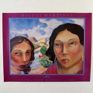 May include: A rectangular art print by Miguel Martinez featuring two figures with dark hair against a landscape of mountains and blue sky. The print includes the text MIGUEL MARTINEZ at the top and TAOS NEW MEXICO 1985 at the bottom on a magenta border.