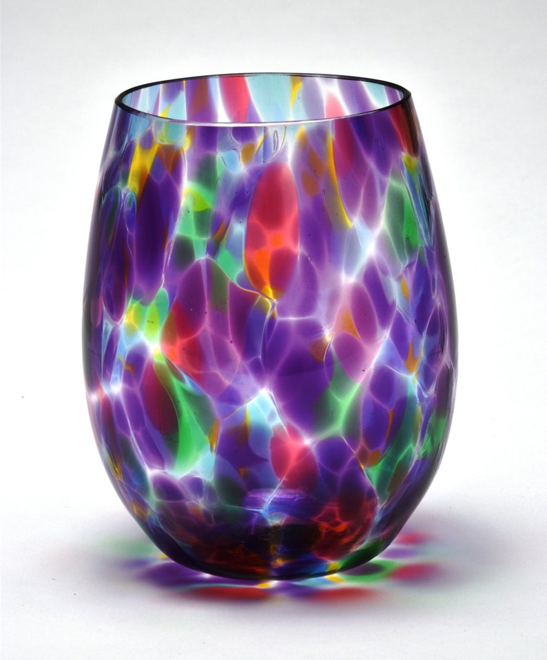 May include: A colorful glass vase with a swirled pattern in shades of purple, red, green, and blue.