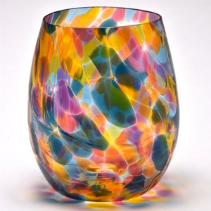 May include: A colorful glass vase with a swirling pattern of blue, yellow, pink, and green. The vase is made of clear glass with a textured surface.