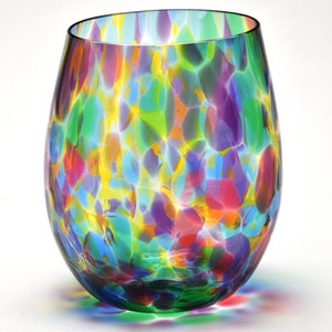 May include: A colorful glass wine glass with a speckled pattern in shades of green, blue, yellow, purple, and red.