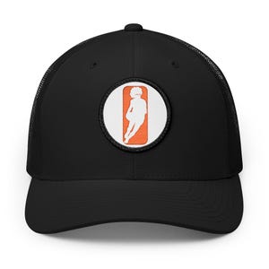 May include: A black trucker hat featuring a circular patch on the front panel. The patch displays a white silhouette of a basketball player dribbling a ball against a solid orange rectangular background, enclosed within a white circular border.