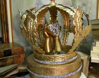 Golden sculpture hands with sacred heart under a crown dome and base, religious Santos symbol one of a kind decor Anita Spero Design