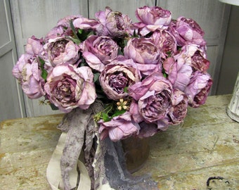 Shabby chic wilted weathered artificial peonies in an antique canvas bucket, very full bouquet in aged deep canvas pail anita spero design