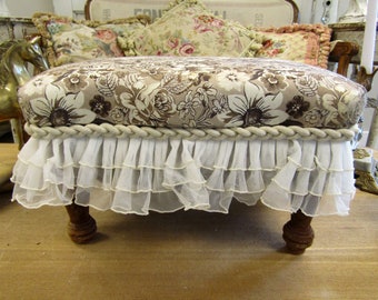 Vintage footrest stool in a white beige to brown floral fabric with floral embellishment accents country cottage home anita spero design