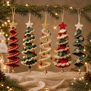 May include: Five spiral-shaped crochet Christmas tree ornaments hanging from a branch. Each tree features a star topper and unique decorations including small bells, miniature gift boxes, white pom-poms, and gold snowflake accents in red, green, and cream.