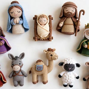 May include: A collection of ten crocheted figures representing a nativity scene, including a baby in a manger, figures in robes, a donkey, a camel, a sheep, and a cow. Each figure is crafted with yarn in various colors, featuring embroidered facial details.