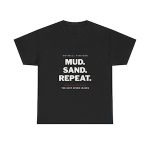 May include: A black short-sleeve t-shirt featuring white text that reads DRYWALL FINISHER MUD. SAND. REPEAT. with a thin orange horizontal line below the text and the additional white text THE DUST NEVER LEAVES at the bottom center.