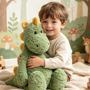 Peut inclure: Une peluche dinosaure en fourrure texturée vert sauge avec des épines jaunes le long du dos. Ce jouet en peluche présente un museau arrondi, de petits yeux noirs et un corps doux et duveteux, conçu comme un compagnon câlin pour les enfants.