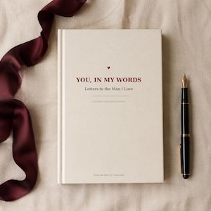 May include: A cream-colored hardcover journal with the title YOU, IN MY WORDS Letters to the Man I Love printed in dark red text. A small red heart sits above the title, and the text A GUIDED KEEPSAKE JOURNAL and From the Dear S. Collection appear below.