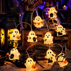 May include: A string of LED lights featuring white ghost-shaped covers. Each ghost displays unique black graphics including a tombstone with RIP, a black cat, a bat, a spider, or an orange pumpkin bucket. Some ghosts feature the text BOO.