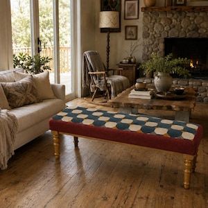 May include: A rectangular bench featuring a top cushion with a geometric pattern in shades of blue, cream, and mustard yellow. The base of the bench is upholstered in a solid dark red fabric, supported by four turned wooden legs with a light finish.