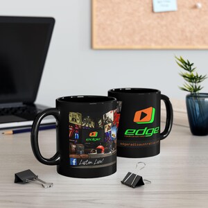 May include: Two black ceramic mugs featuring the Edge Radio Australia logo. One mug displays a graphic of a studio interior with the text "Listen Live!" and a Facebook icon. The other mug shows the orange and green logo with the website address.