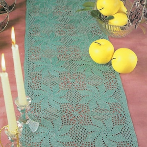 May include: A teal crochet table runner with a pinwheel design. The runner is called "Pinwheel Runner" and is part of the "Perfect Pinwheels" collection.