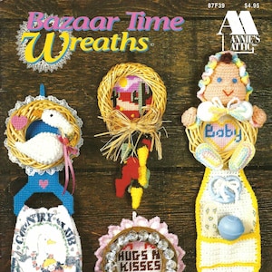 May include: A set of seven plastic canvas wreath patterns featuring a variety of designs, including a baby, a goose, a country club, and a wreath with the words "Hugs & Kisses".