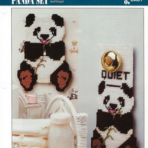 May include: A panda-themed baby set, featuring a door cover with the word "QUIET" and a light switch cover. Both are white, black, and brown, with a panda design. The set is designed by Brett Ebright.