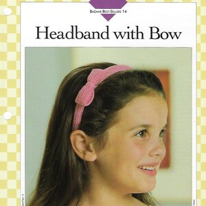 May include: A pink crocheted headband with a bow. The headband is worn by a young girl with long brown hair. The text "Headband with Bow" is printed in black at the top of the image.
