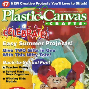 May include: The cover of "Plastic Canvas Crafts" magazine, August 2000, features a stitched teddy bear with balloons and the words "Happy Bearthday." Additional text includes "Celebrate!" and project ideas like a teacher bunny and desk organizer.
