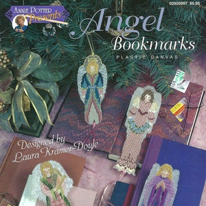 May include: A craft book featuring four angel bookmark designs on plastic canvas. The book cover features the title "Angel Bookmarks" and the words "Plastic Canvas". The book is designed by Laura Kramer-Doyle.
