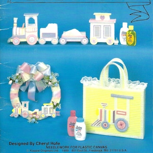 May include: A plastic canvas needlework pattern book titled "Baby Time" with a train, a house, a wreath, and a tote bag. The book is designed by Cheryl Hofe and is for plastic canvas needlework.