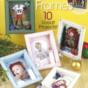 May include: A craft pattern book titled Plastic Canvas Shadow Box Frames featuring 10 projects. The cover displays five rectangular frames in green, pink, white, and blue, decorated with small stitched items like sports gear, toys, and flowers.