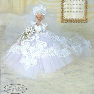 May include: A doll in a white wedding dress with a lace bodice, veil, and bouquet. The doll has blonde hair and is posed in front of a painted backdrop. A calendar for January 1998 is in the background. The text "An Annie Potter Original" is at the bottom.