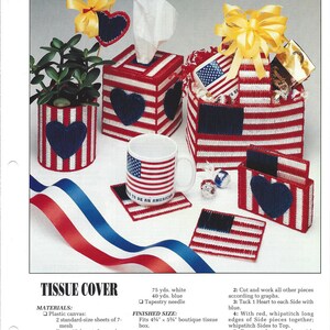 May include: A plastic canvas craft project featuring a tissue box cover, a mug, and coasters. The design is a red, white, and blue American flag with hearts. The project is titled "Hearts & Stripes" and includes instructions for making the items.