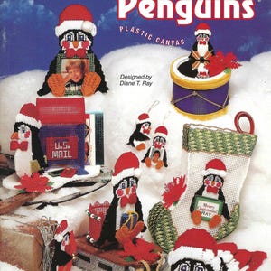 May include: A craft project pattern featuring a variety of Christmas penguins. The penguins are depicted in different poses, including holding a gift, a mailbox, and a picture frame. The pattern is titled "Christmas Penguins" and is designed by Diane T. Ray.