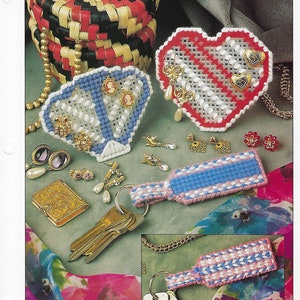 May include: A collection of handmade key ring and earring holders. The image features a variety of designs, including a heart, a diamond shape, and a bottle-shaped key ring. The holders are adorned with various earrings and keys. The text "KEY RING & EARRING HOLDERS" is visible.