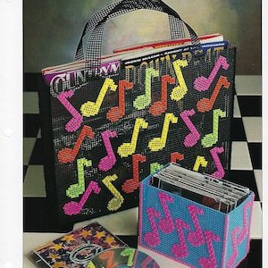 May include: A plastic canvas tote bag and a CD holder with a musical note design. The tote bag is black with pink, yellow, and green musical notes. The CD holder is blue with pink musical notes. The text "QUICK & EASY" is in the top right corner of the image.